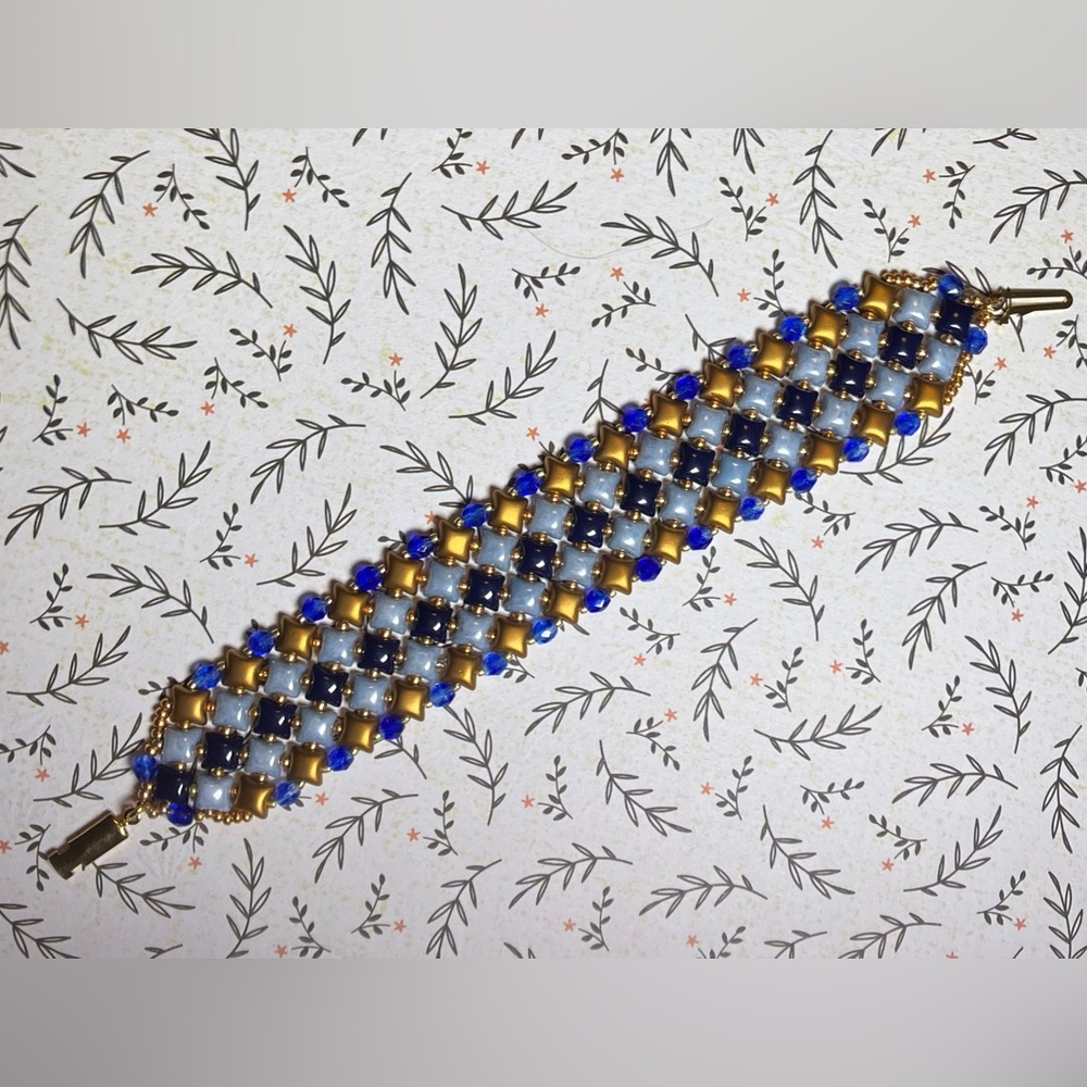 Handmade fashion jewelry bracelet in blue and gold.